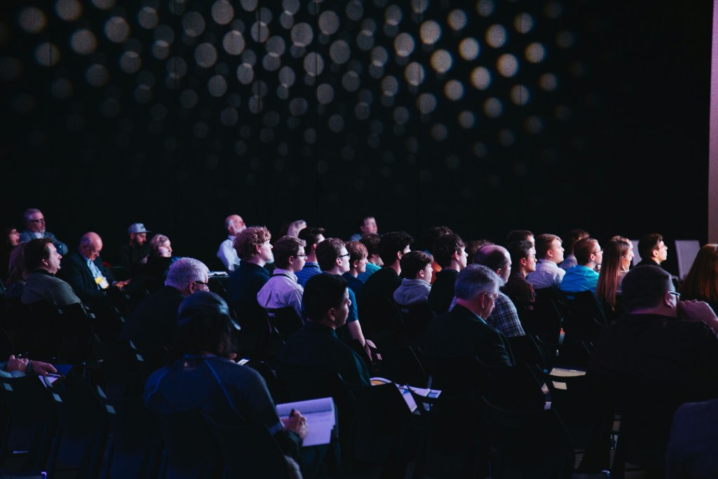 Attendees brainstorming during a creative workshop at a conference.